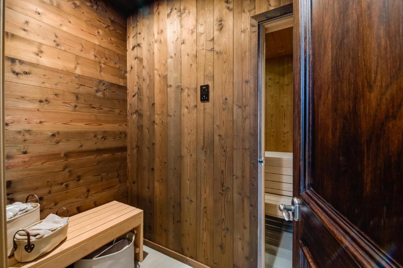 Tiled anteroom with stained-wood door and digital controls