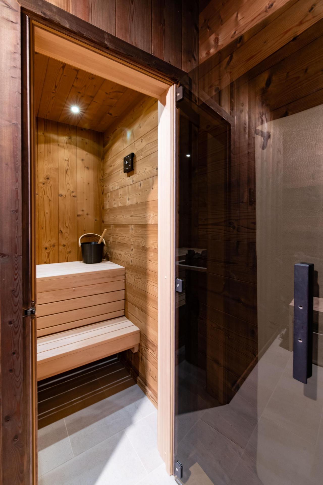 Smoked-glass door opening from the bath into the sauna